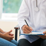 patient having consultation with doctor, gynecologist or psychiatrist and examining health female illness, writing prescription clipboard record, Medical clinic in hospital cocept.