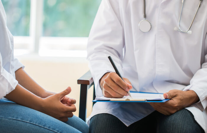patient having consultation with doctor, gynecologist or psychiatrist and examining health female illness, writing prescription clipboard record, Medical clinic in hospital cocept.