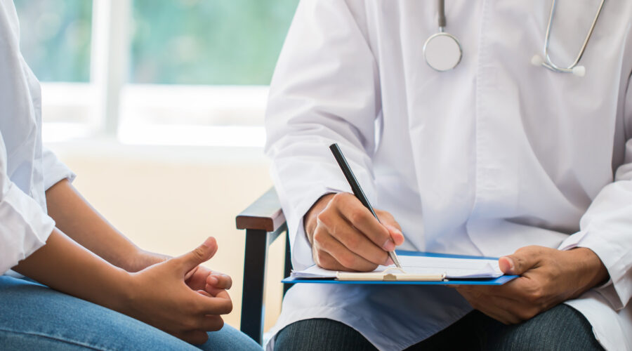 patient having consultation with doctor, gynecologist or psychiatrist and examining health female illness, writing prescription clipboard record, Medical clinic in hospital cocept.
