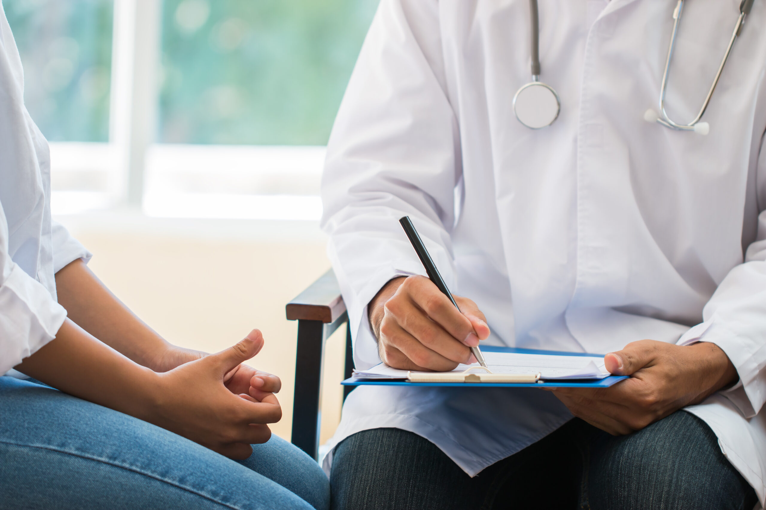 patient having consultation with doctor, gynecologist or psychiatrist and examining health female illness, writing prescription clipboard record, Medical clinic in hospital cocept.